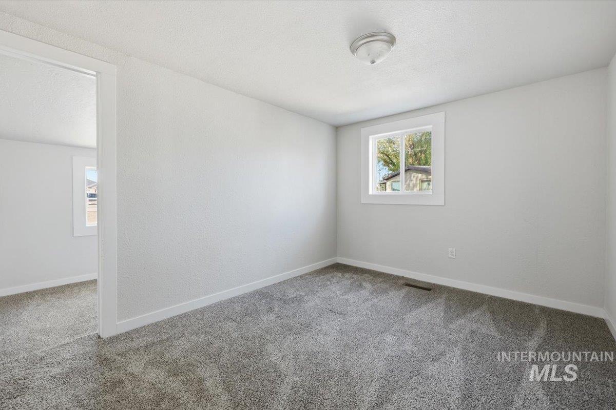 956 Southeast Hamilton Road Mountain Home, ID 83647 - Photo 29 of 34 Neutral gray carpeting extending throughout the space
