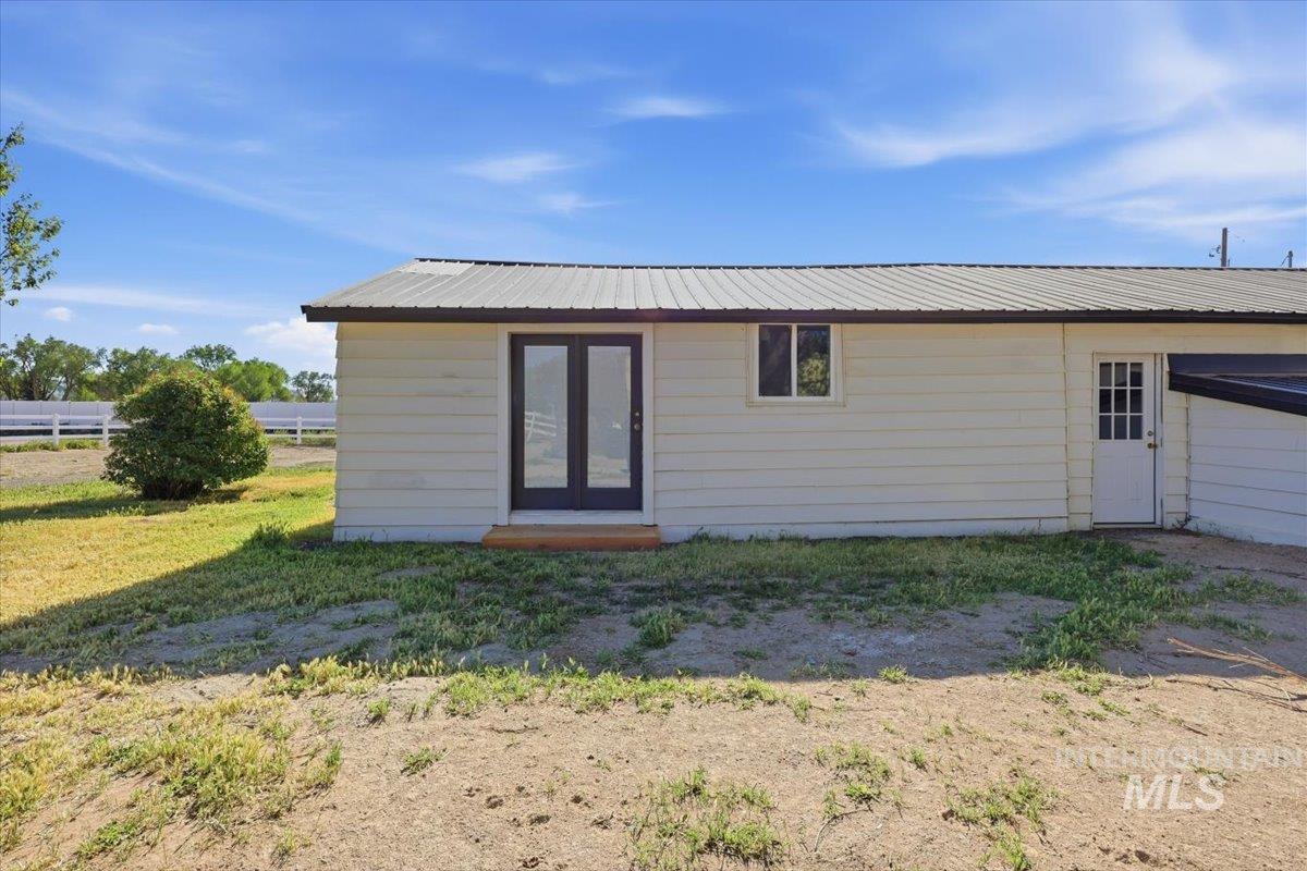 956 Southeast Hamilton Road Mountain Home, ID 83647 - Photo 6 of 34 Cream-colored siding exterior featuring a metal roof