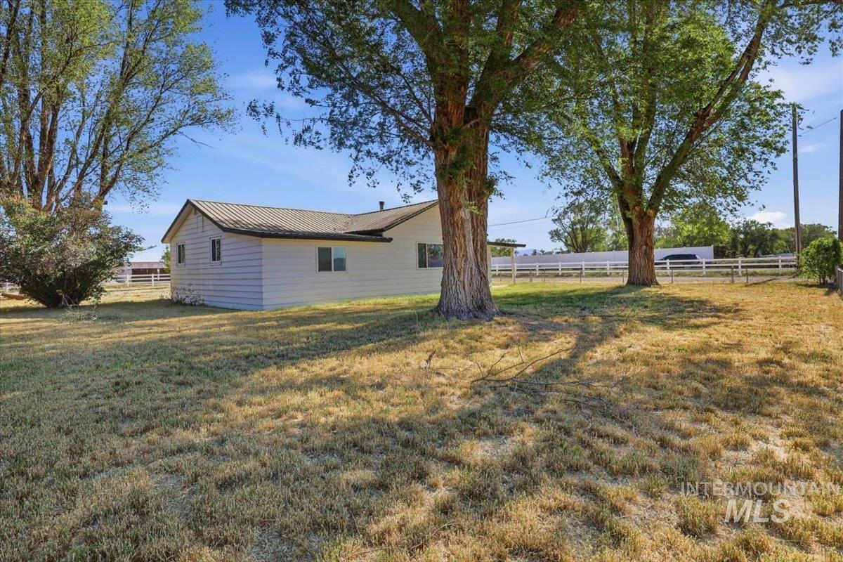 956 Southeast Hamilton Road Mountain Home, ID 83647 - Photo 7 of 34 Exterior residence with white siding and a dark metal roof