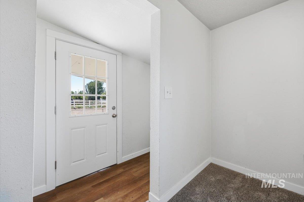 956 Southeast Hamilton Road Mountain Home, ID 83647 - Photo 8 of 34 Entryway featuring a white door with divided light windows and wood-finish flooring