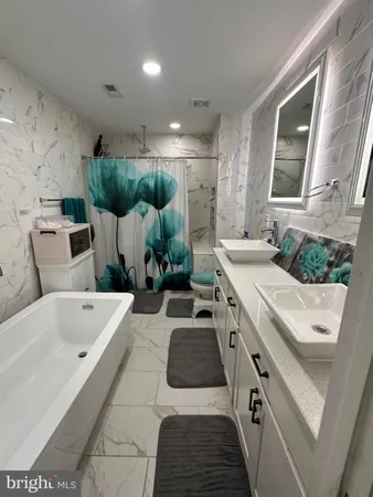 a bathroom with a tub sink and mirror
