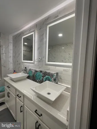 a bathroom with a sink and mirror