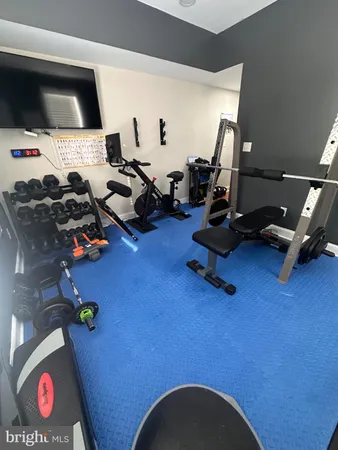 a room with gym equipment and a flat screen tv