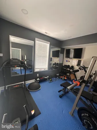 a room with gym equipment and a large window