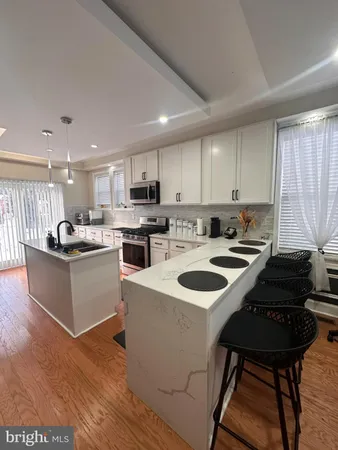 a kitchen with a sink stove and white cabinets