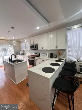 a kitchen with a stove a sink and a refrigerator
