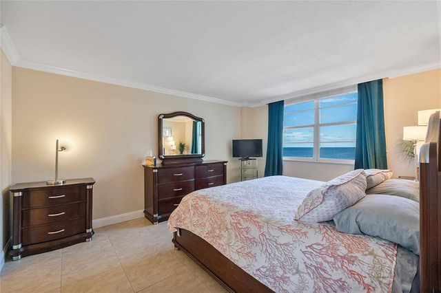 a bathroom with a granite countertop sink a mirror and a bathtub