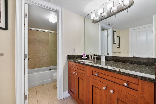 a white bath tub sitting next to a white toilet and sink