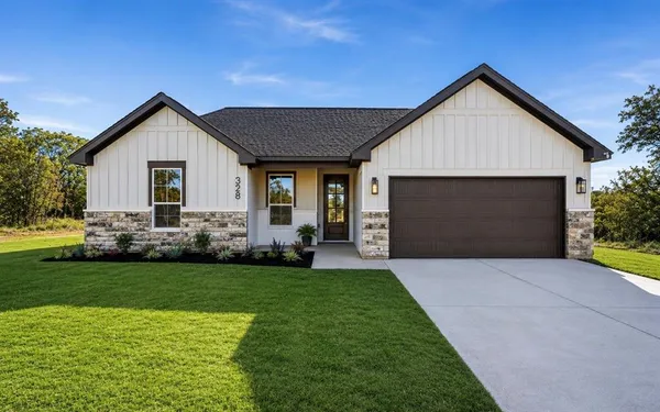 a front view of house with yard and green space