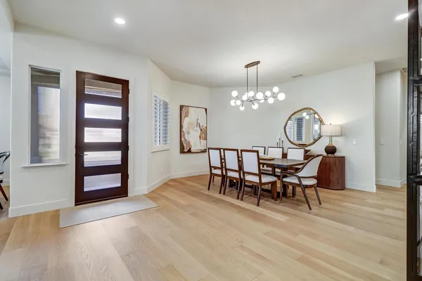 a living room with dining table and chairs