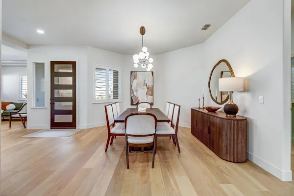a view of a dining room with furniture and a chandelier