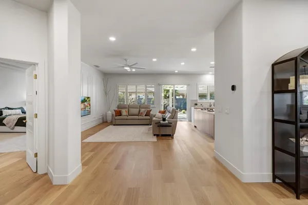 a living room with furniture and a painting on the wall