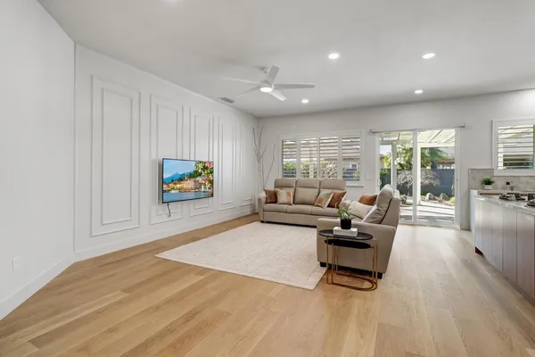 a living room with furniture and kitchen view