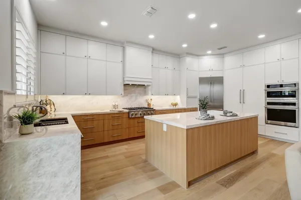 a kitchen with stainless steel appliances granite countertop a sink and a window