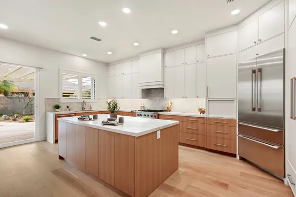 a kitchen with stainless steel appliances granite countertop a sink stove and cabinets