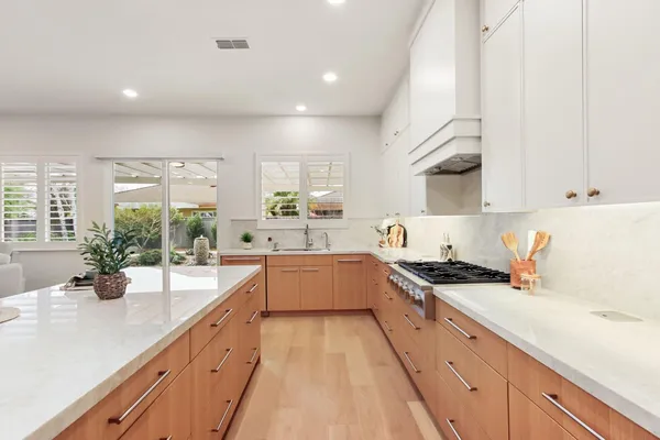 a kitchen with cabinets and stainless steel appliances