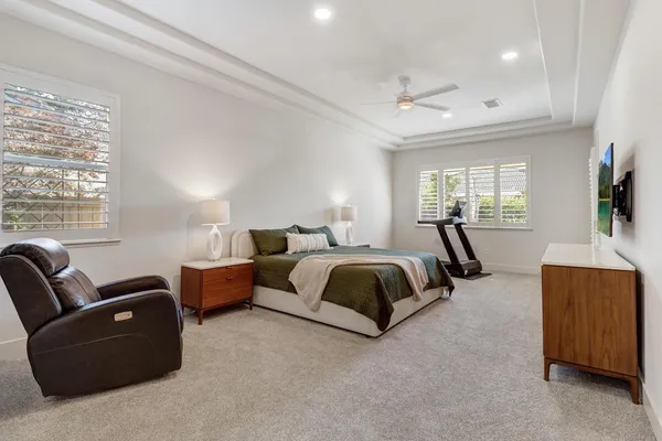 a bedroom with a bed and a chandelier