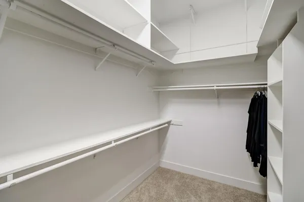 a bedroom with a bed window and a chandelier fan