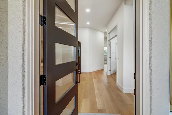 a living room with furniture a fireplace and a large window