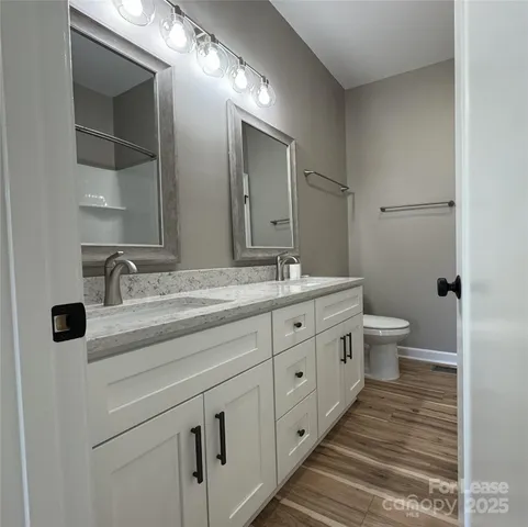 a bathroom with double sink and a large mirror