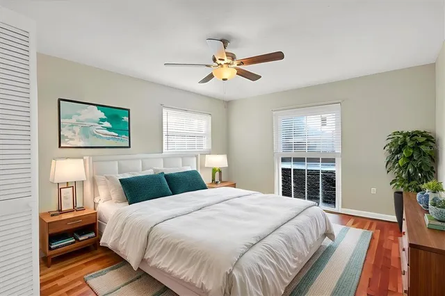 a bedroom with a large bed and a chandelier