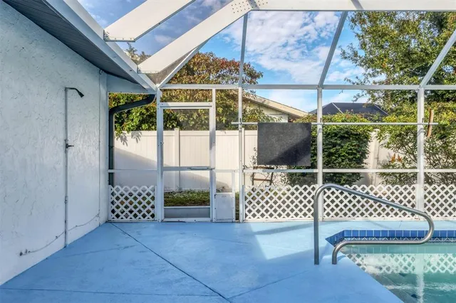 a view of a yard with plants and trees