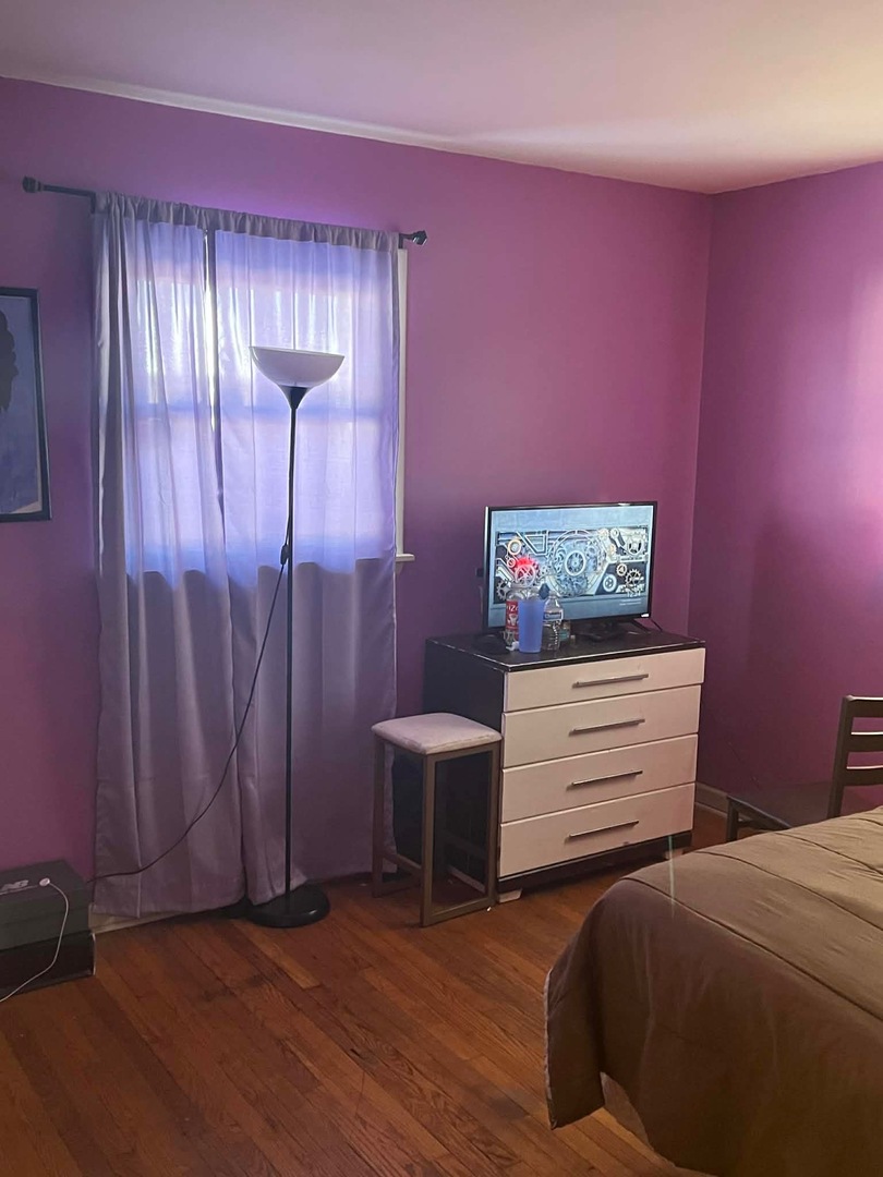 1716 West 163rd Street Markham, IL 60428 - Photo 8 of 9 a bedroom with a bed and a table in it