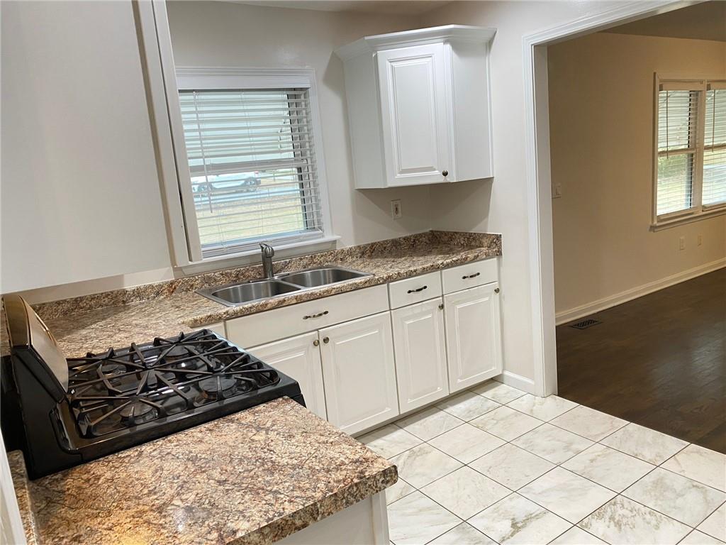 330 Community Drive Mableton, GA 30126 - Photo 13 of 47 a kitchen with stainless steel appliances granite countertop a stove a sink and a microwave