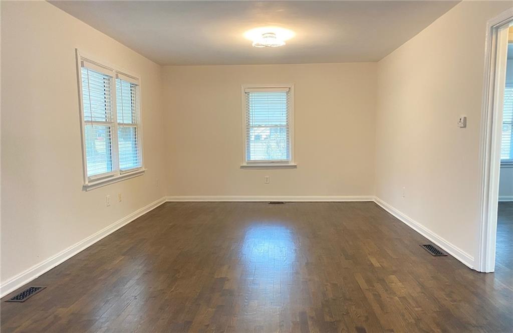330 Community Drive Mableton, GA 30126 - Photo 16 of 47 a view of an empty room with wooden floor and a window