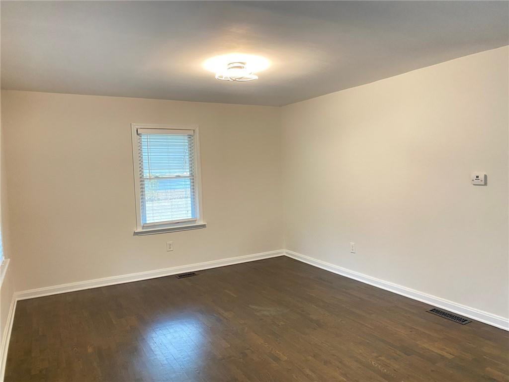 330 Community Drive Mableton, GA 30126 - Photo 18 of 47 an empty room with wooden floor and windows