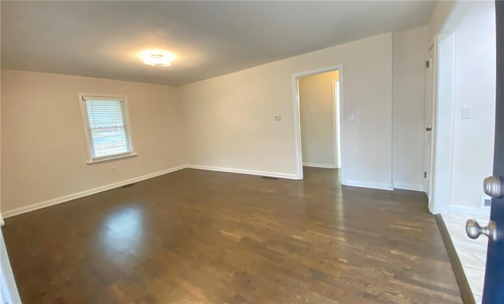 330 Community Drive Mableton, GA 30126 - Photo 22 of 47 an empty room with wooden floor and windows