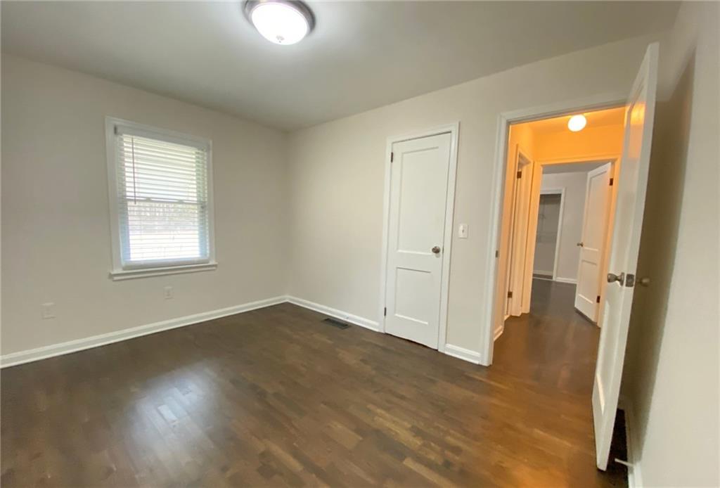 330 Community Drive Mableton, GA 30126 - Photo 35 of 47 an empty room with wooden floor and windows