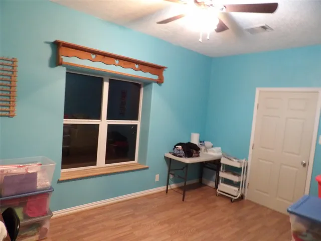 a view of a chairs and table in the back yard