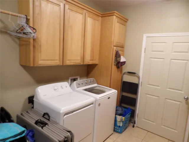 a view of a house with a backyard and trees