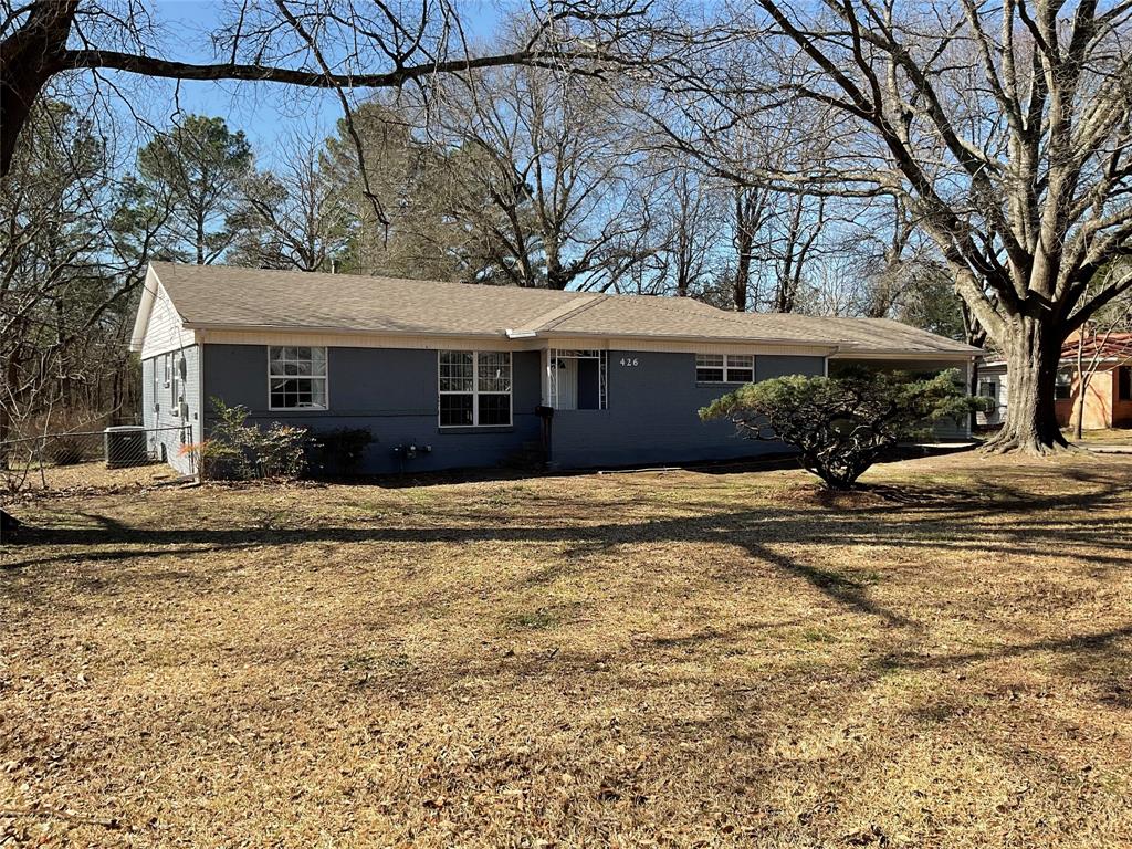 426 Meadow Lane Bonham, TX 75418 - Photo 1 of 1 View of front of home with central AC unit, a front lawn, and fence