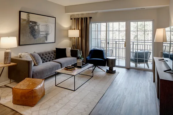 a living room with furniture and a wooden floor