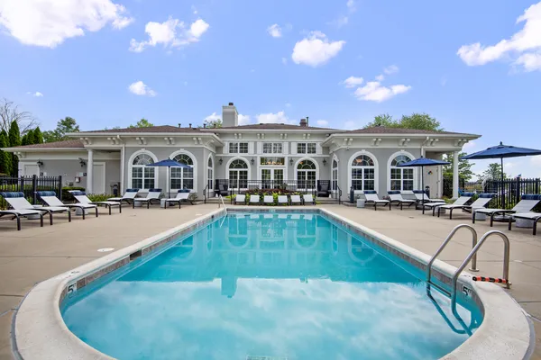 a view of a house with swimming pool and sitting area
