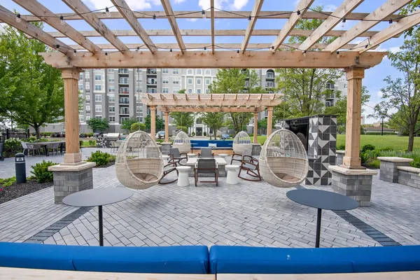 a view of a patio with a dining table and chairs with wooden floor