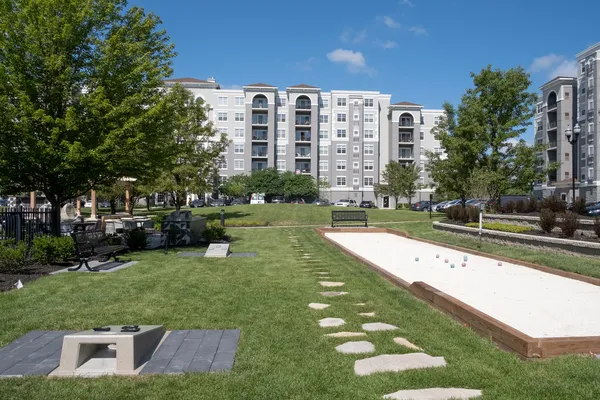 a view of a big building with a big yard and large trees