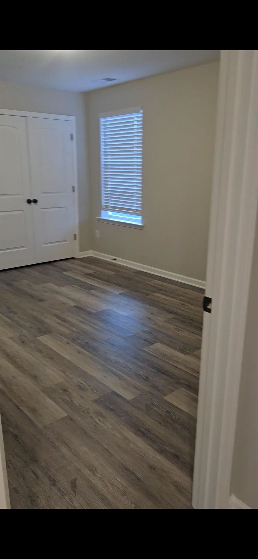 10160 Sterling Ridge Drive Cordova, TN 38018 - Photo 5 of 35 a view of an empty room with wooden floor and a window