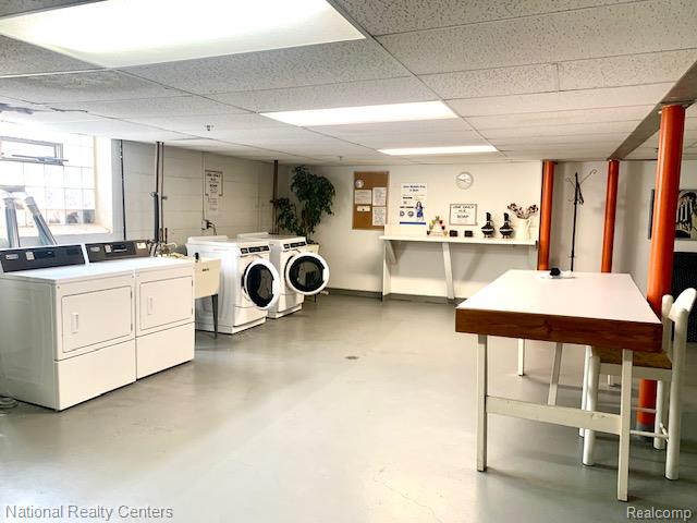 475 South Adams Road, Unit 19 Birmingham, MI 48009 - Photo 16 of 20 Utility space featuring multiple washing machines and dryers, a utility sink, and a built-in shelf
