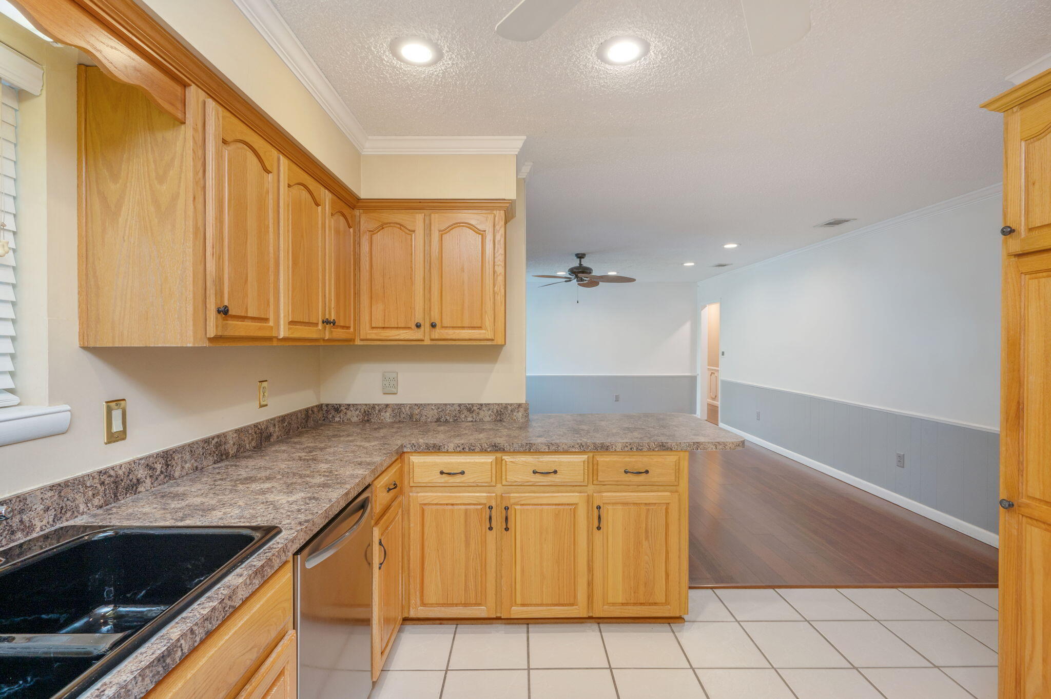 5770 Wildwood Road Crestview, FL 32536 - Photo 14 of 39 a kitchen with a sink a stove cabinets and a counter top space