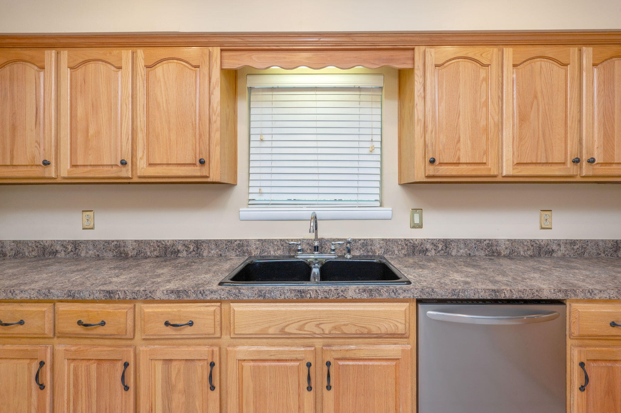 5770 Wildwood Road Crestview, FL 32536 - Photo 15 of 39 a kitchen with granite countertop white cabinets and sink