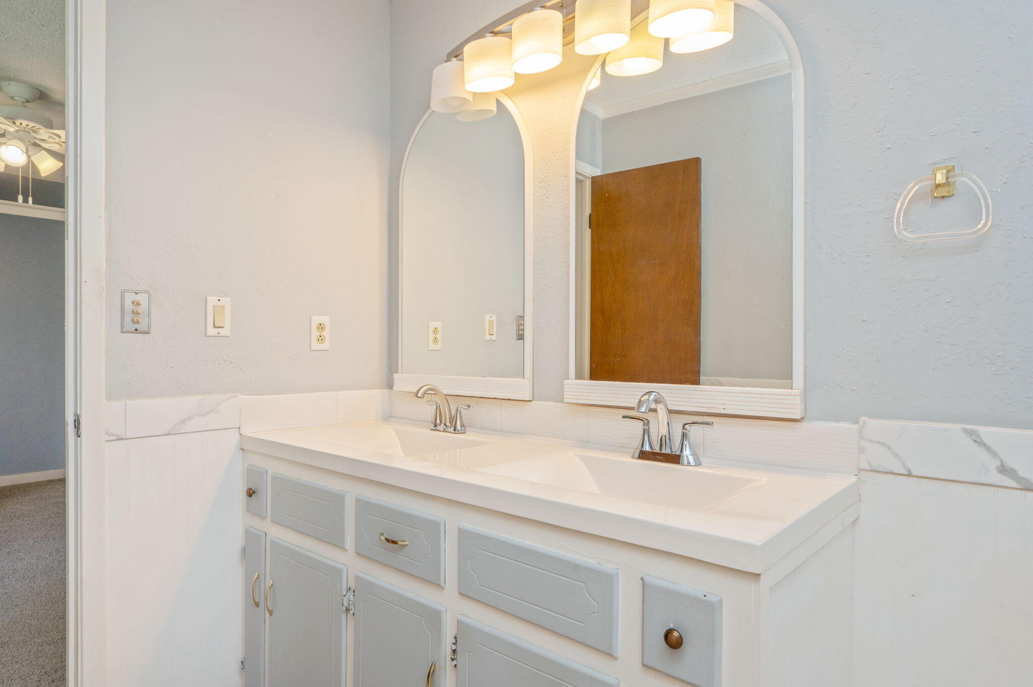 5770 Wildwood Road Crestview, FL 32536 - Photo 21 of 39 a bathroom with a sink vanity and a mirror