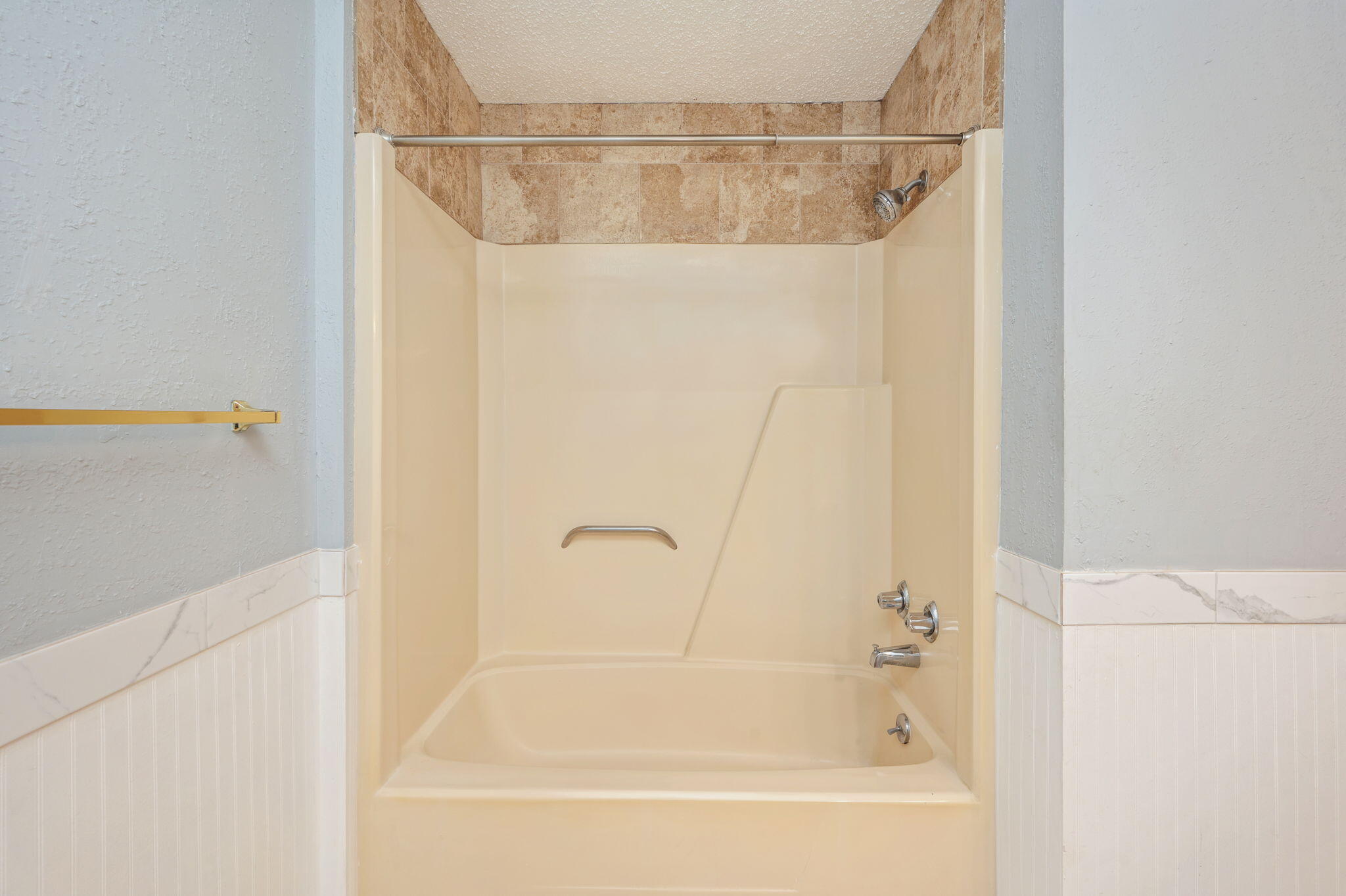 5770 Wildwood Road Crestview, FL 32536 - Photo 22 of 39 a bathroom with a shower and a bath tub