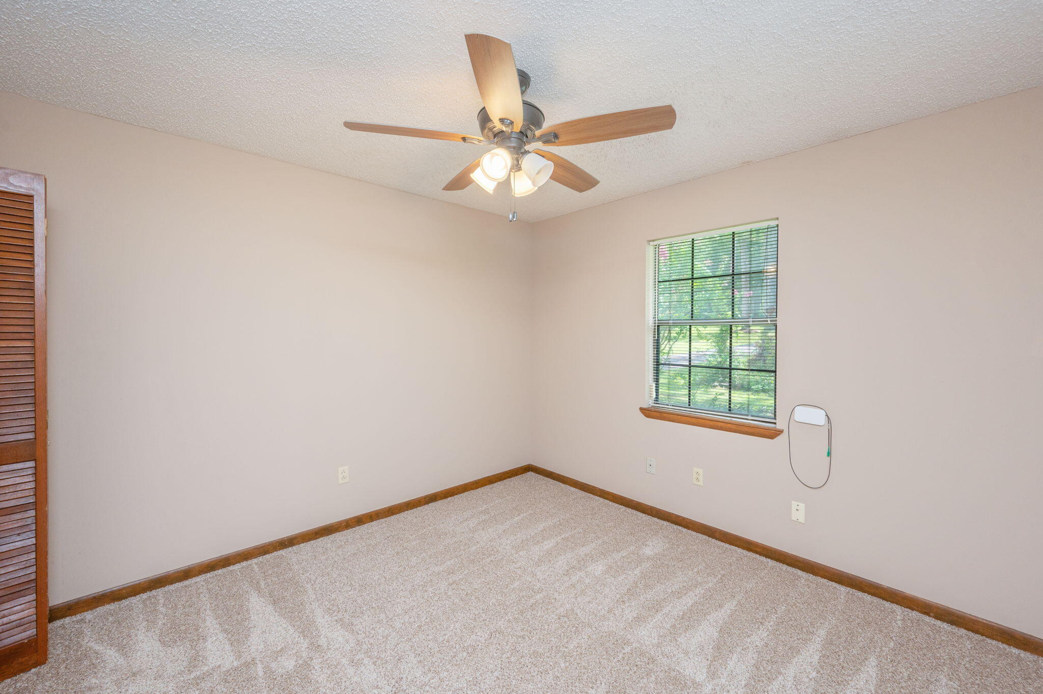 5770 Wildwood Road Crestview, FL 32536 - Photo 25 of 39 an empty room with windows and fan