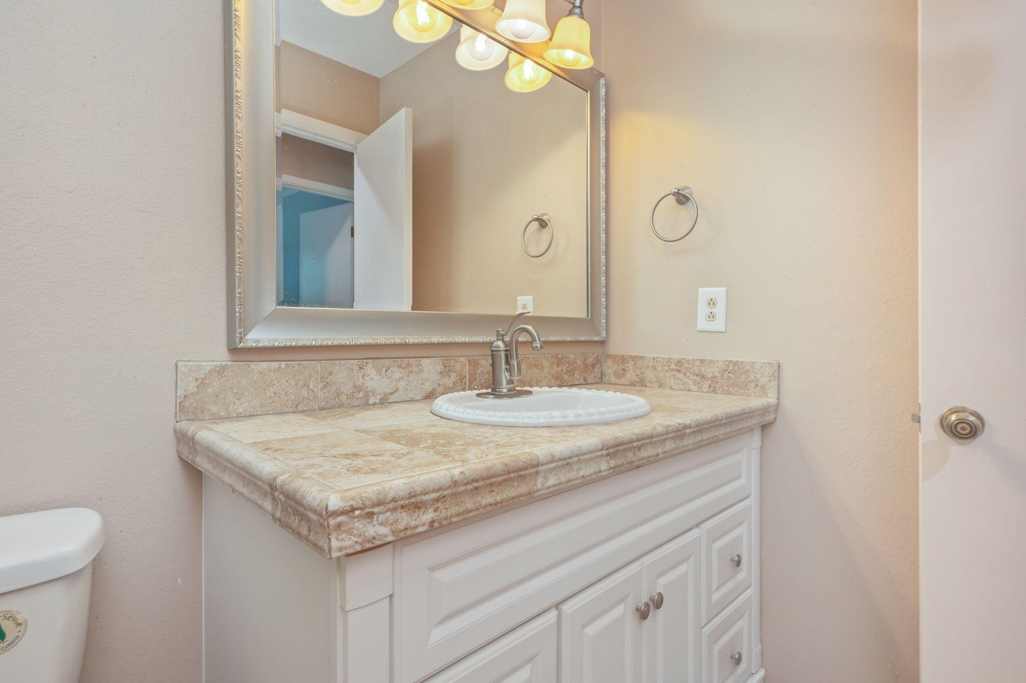 5770 Wildwood Road Crestview, FL 32536 - Photo 27 of 39 a bathroom with a granite countertop sink and a mirror