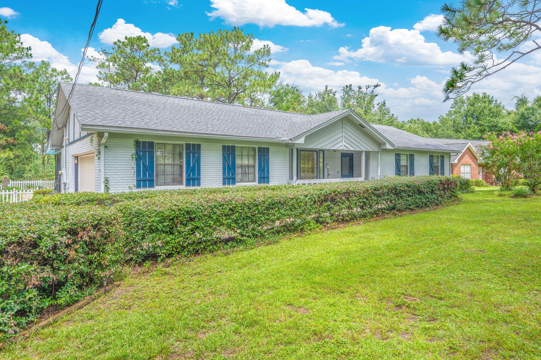 5770 Wildwood Road Crestview, FL 32536 - Photo 3 of 39 a front view of a house with a garden