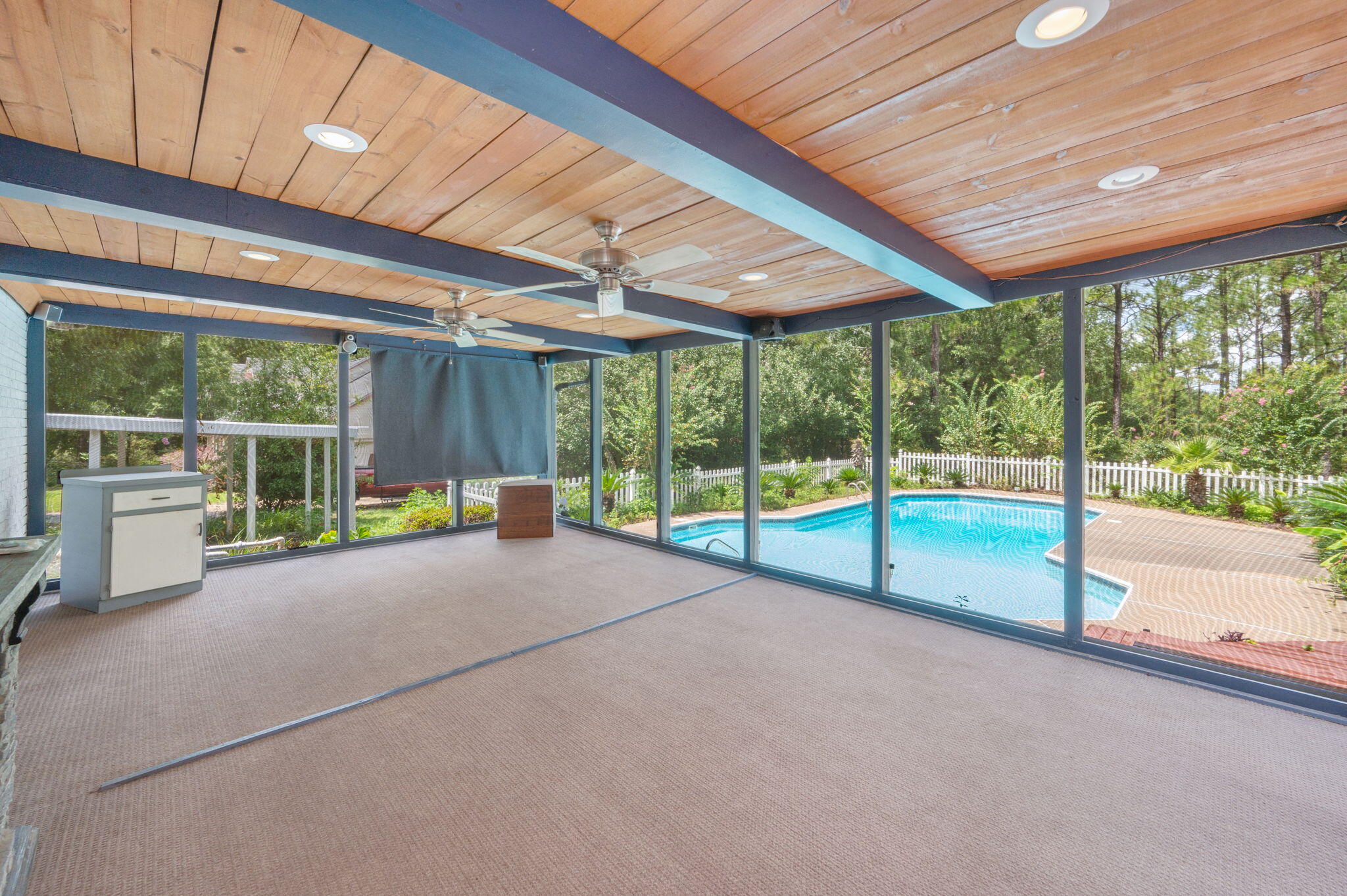 5770 Wildwood Road Crestview, FL 32536 - Photo 32 of 39 a view of an empty room with wooden floor and iron fence