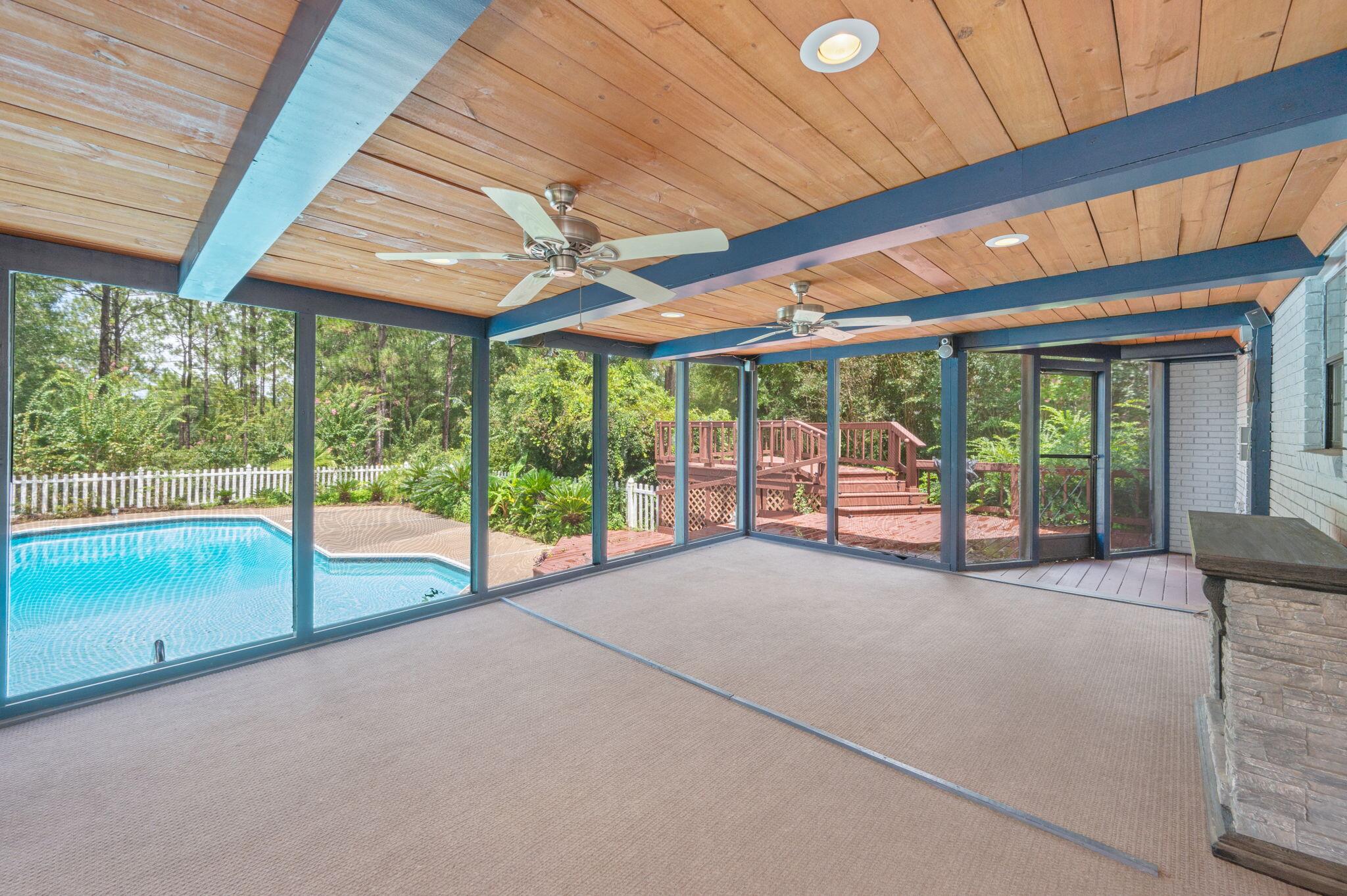 5770 Wildwood Road Crestview, FL 32536 - Photo 34 of 39 a view of an empty room with large windows